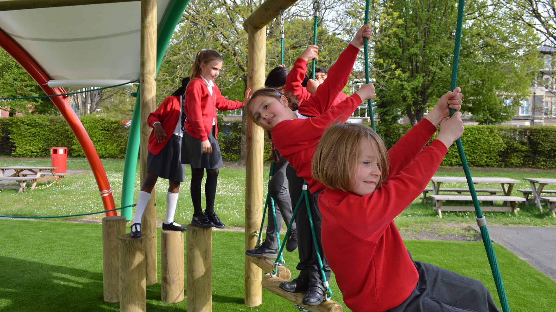 Children at St. Peter's Out of School Care in Cardiff enjoy outdoor activities in the school playground, after school hours.