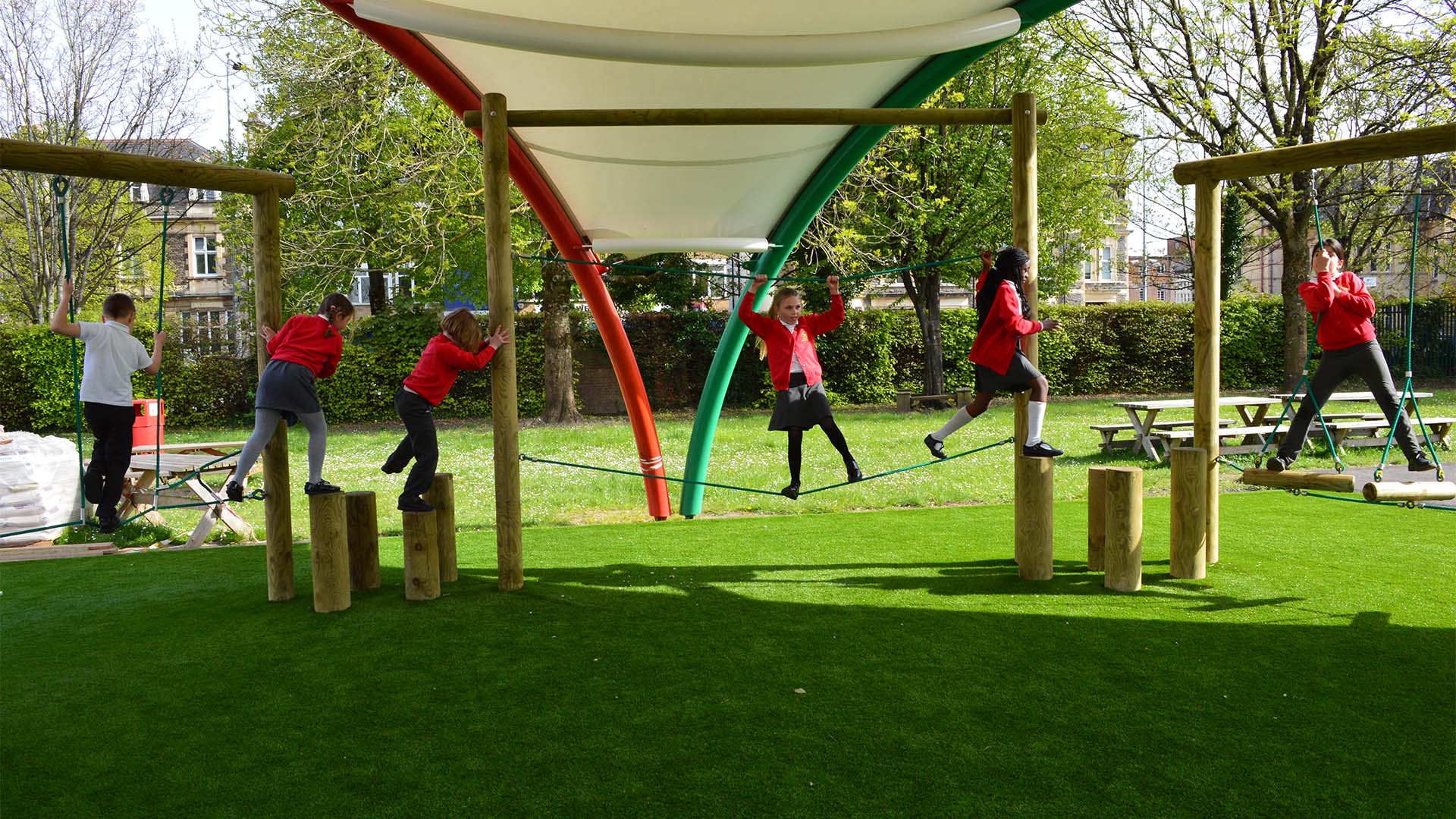 Children at St. Peter's Out of School Care in Cardiff enjoy outdoor activities in the school playground, after school hours.